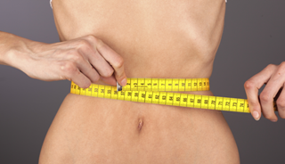 tape measure around small waist with bony ribcage tape measure around small waist with bony ribcage